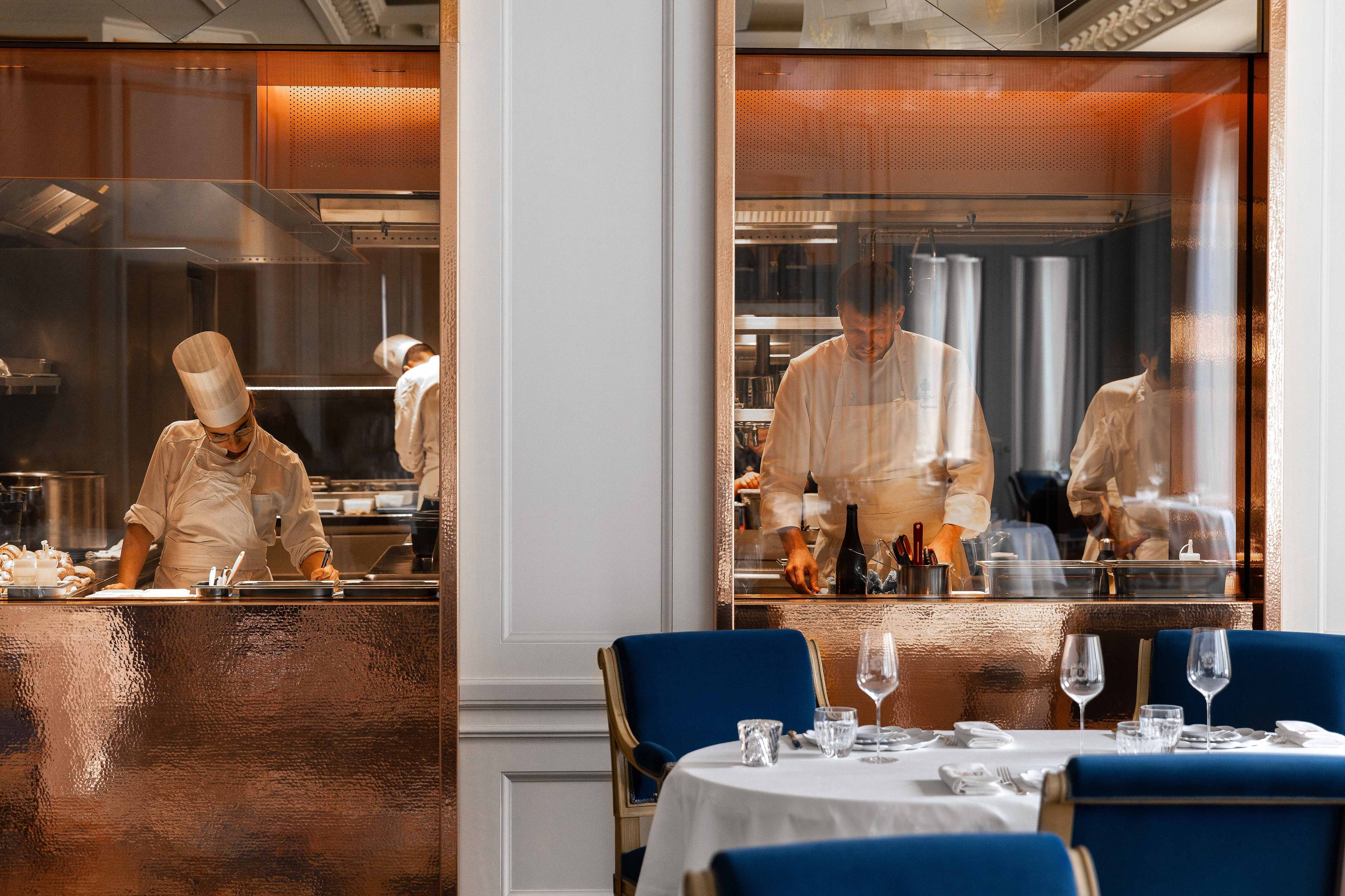 View of the kitchen from the dining room of the L'Espadon Restaurant at the Ritz Paris