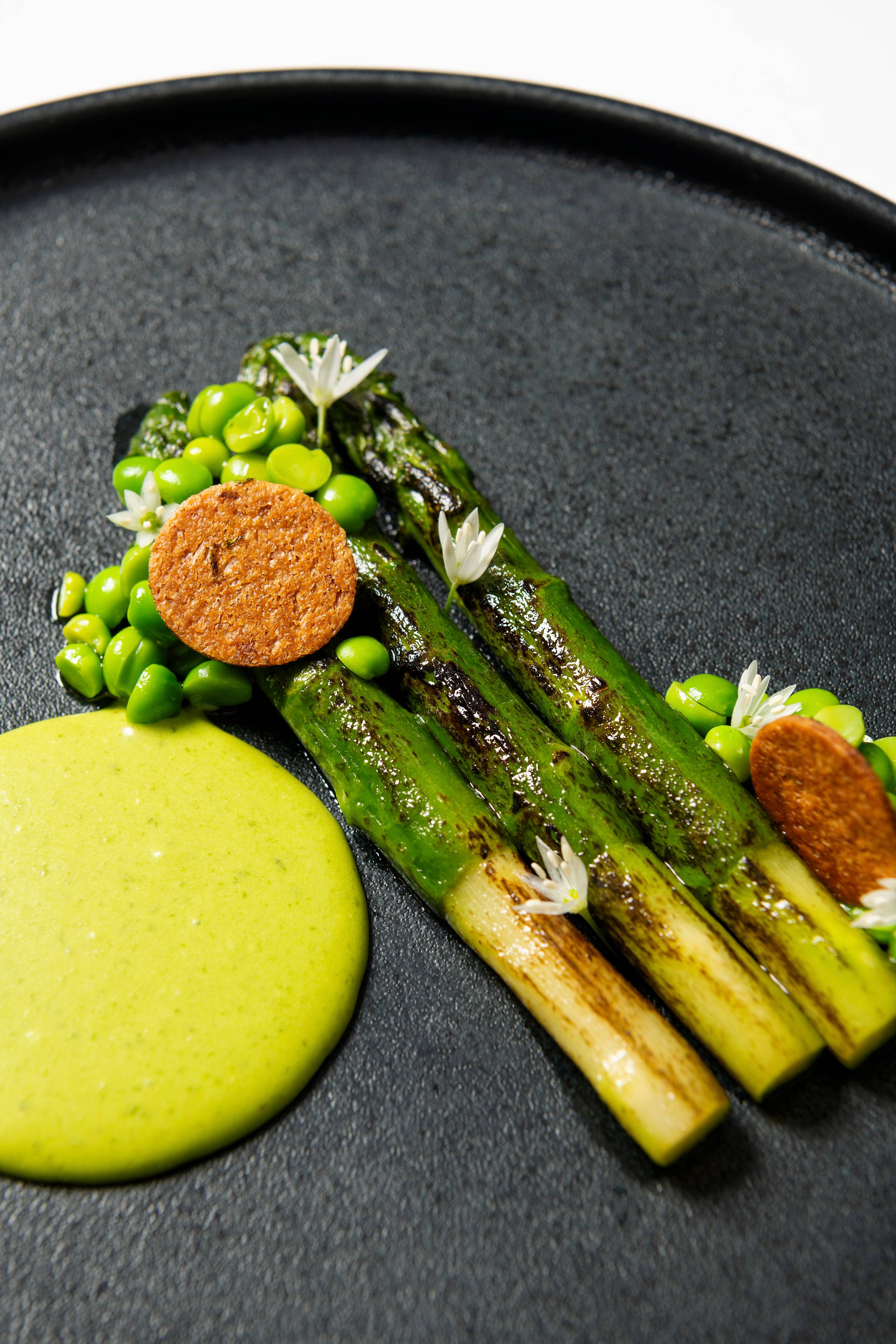 Grilled green asparagus with wild garlic sabayon